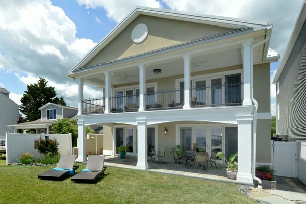 Image of a two-story, colonial-style home in Southern Maryland with Greek-style pillars and a large covered patio.