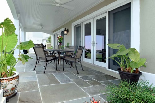 Image of a covered patio of a single-family home in Calvert County, MD, with stone tile flooring 