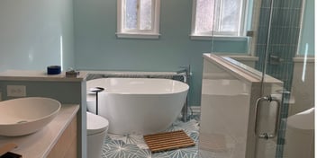 Modern bathroom renovation featuring a freestanding tub and elegant vanity by Villa Builders in Southern Maryland