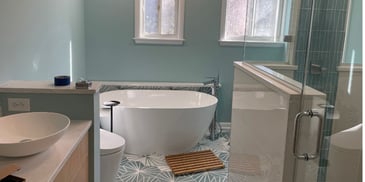 Modern bathroom renovation featuring a freestanding tub and elegant vanity by Villa Builders in Southern Maryland