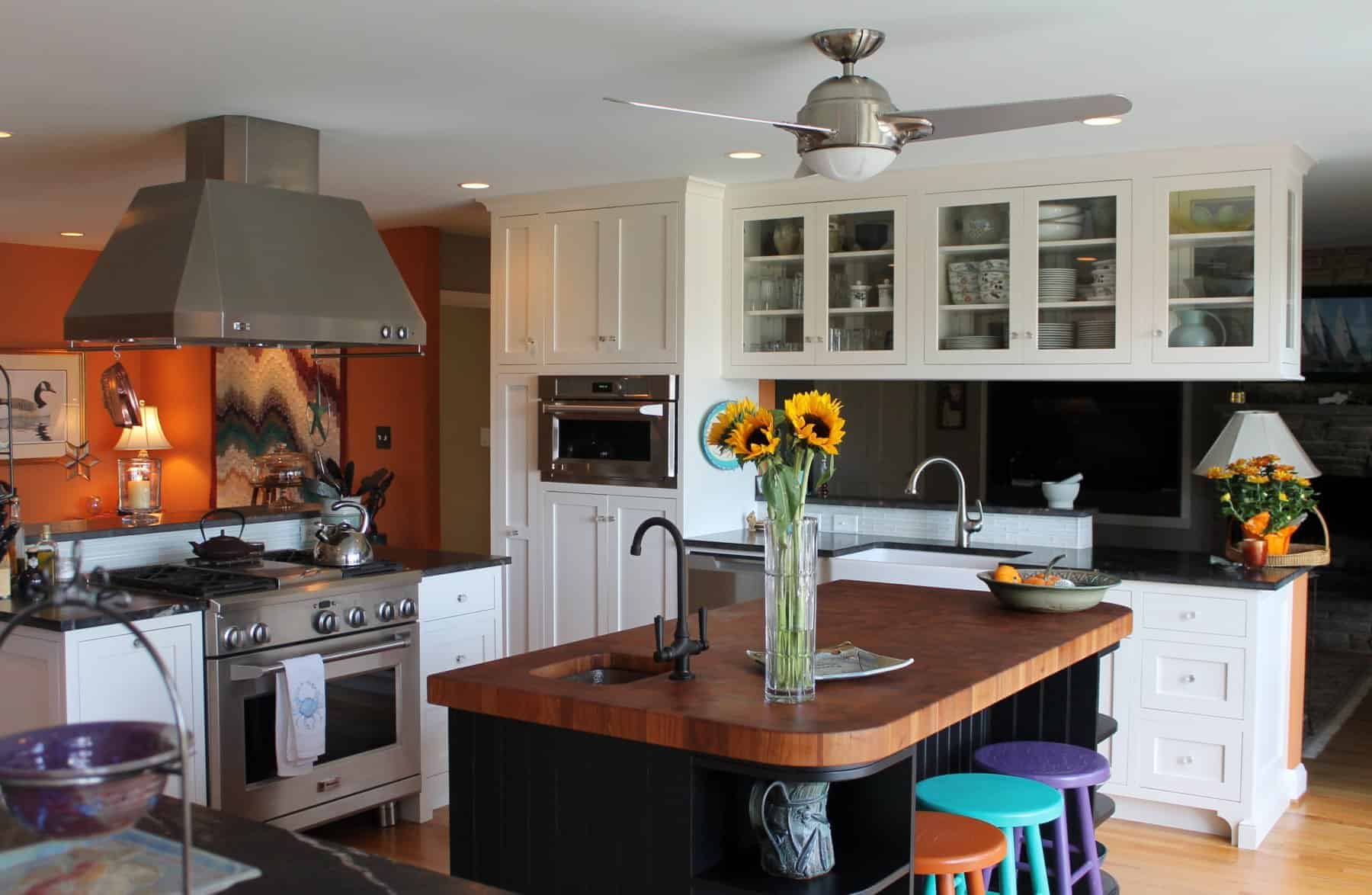 Contemporary kitchen design featuring a central island, stainless steel appliances, and vibrant decor by Villa Builders in Annapolis, Maryland