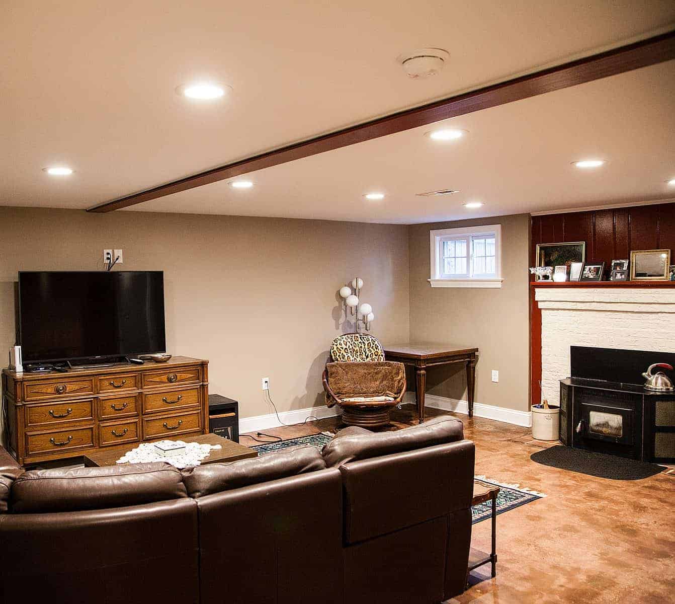 Basement living area with TV and leather sofa by Villa Builders in Annapolis, Maryland