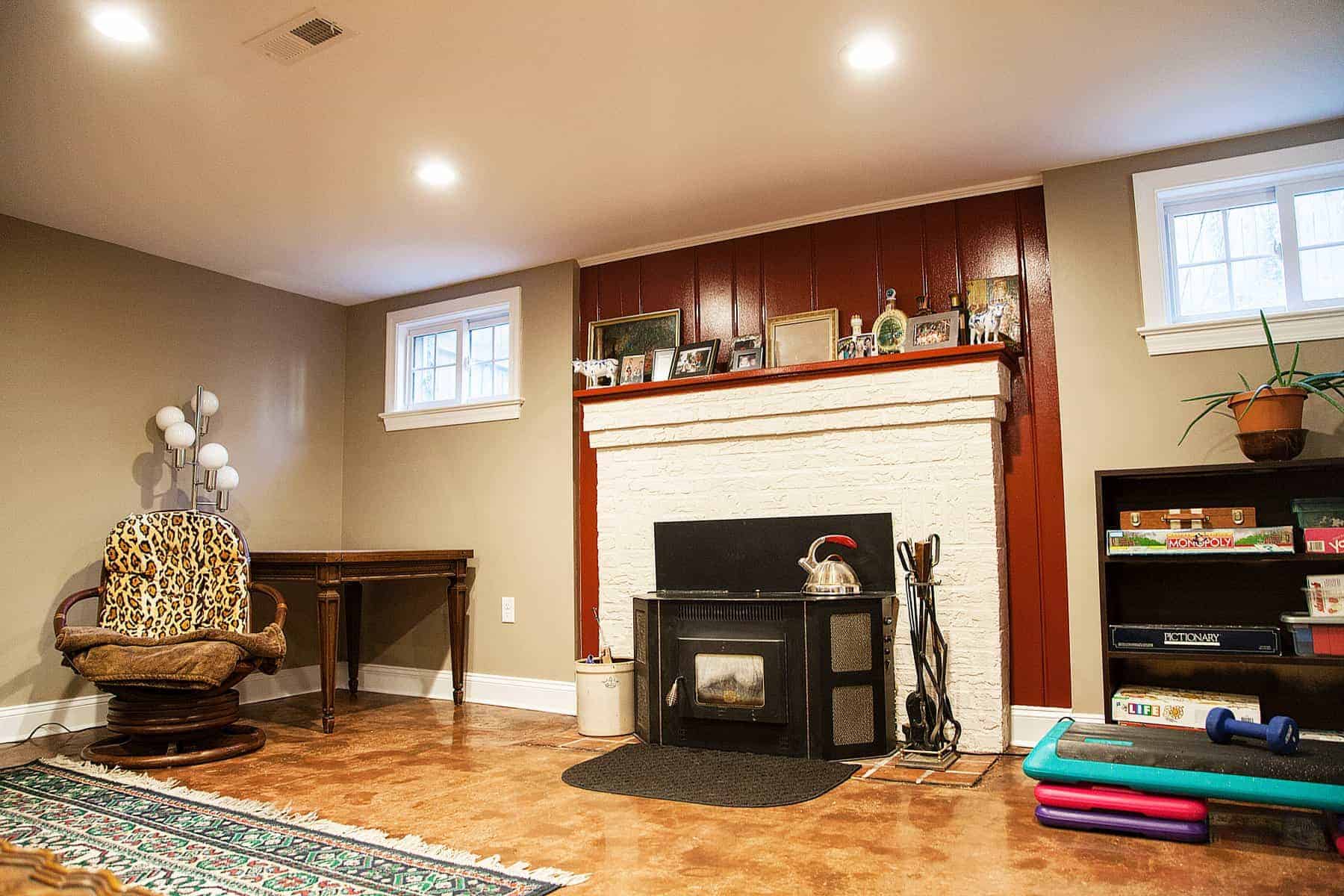 Living room with fireplace and leopard-print chair by Villa Builders in Annapolis, Maryland