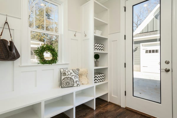 Bright and organized mudroom with built-in shelves and bench, designed by Villa Builders in Southern Maryland