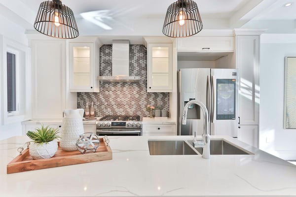 Elegant kitchen renovation with a marble countertop and backsplash by Villa Builders in Southern Maryland