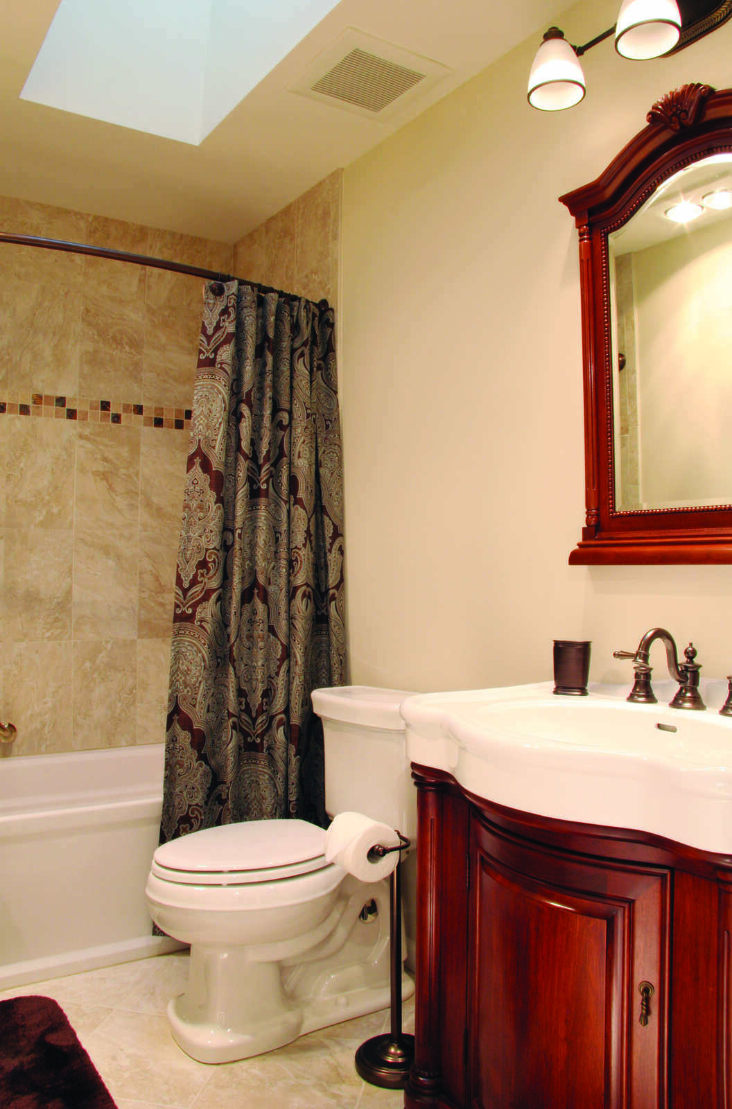 Vintage-style bathroom with a red-framed mirror and custom vanity in a remodel by Villa Builders in Annapolis, MD Vintage-style bathroom with a red-framed mirror and custom vanity in a remodel by Villa Builders in Annapolis, MD