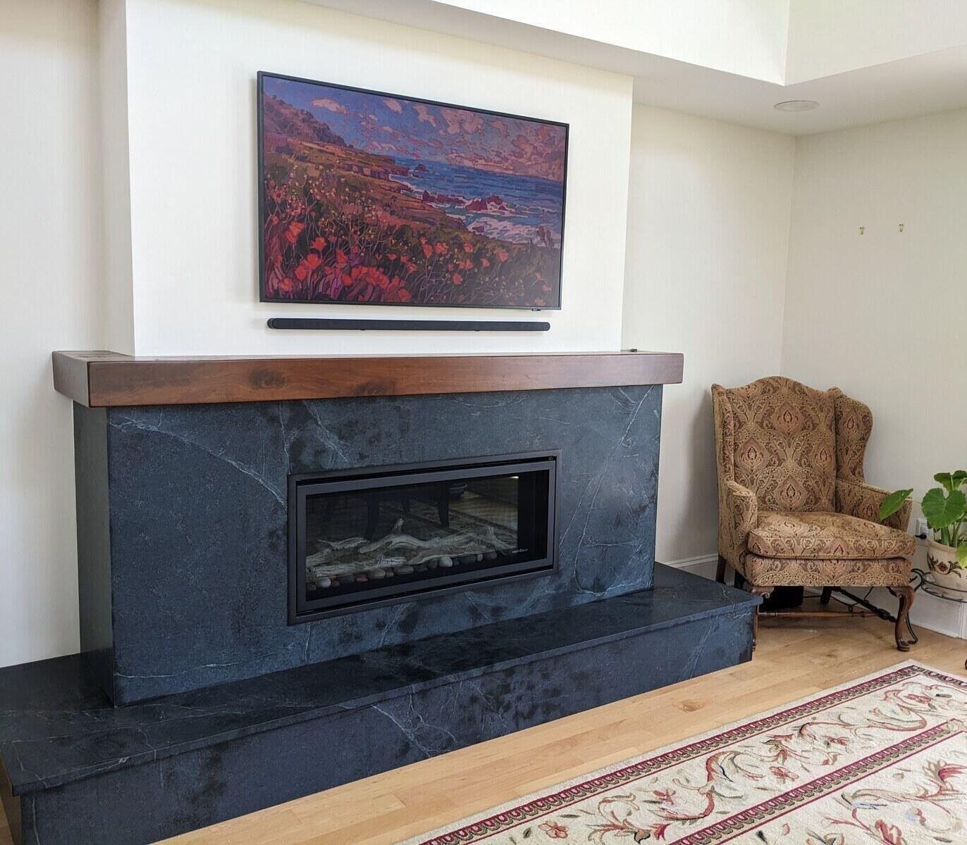 Modern living space featuring a sleek black fireplace and vibrant wall art, designed by Villa Builders in Annapolis, MD Modern living space featuring a sleek black fireplace and vibrant wall art, designed by Villa Builders in Annapolis, MD