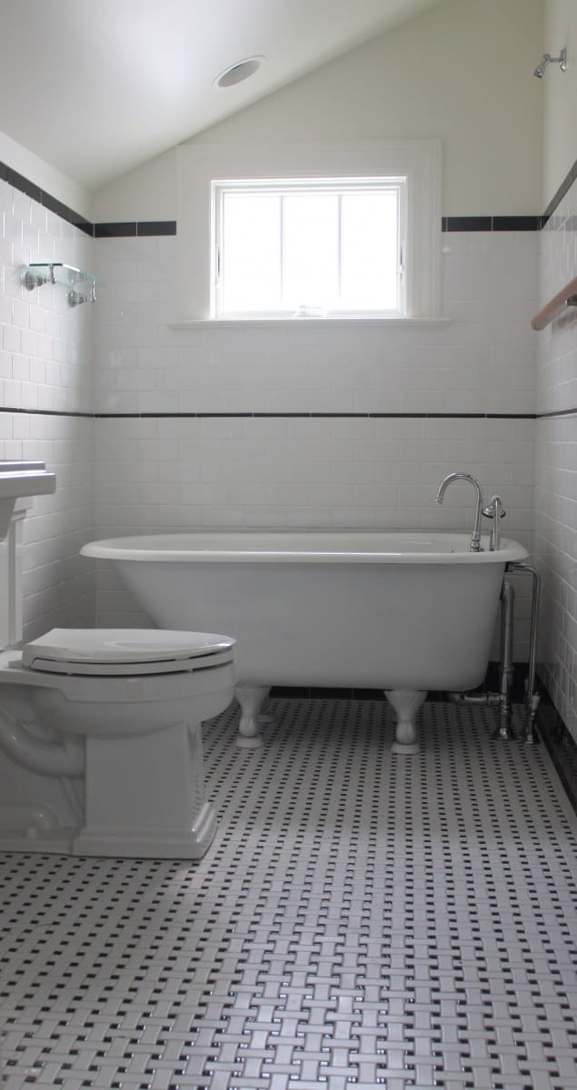 Classic white bathroom with clawfoot tub by Villa Builders in Annapolis, Maryland