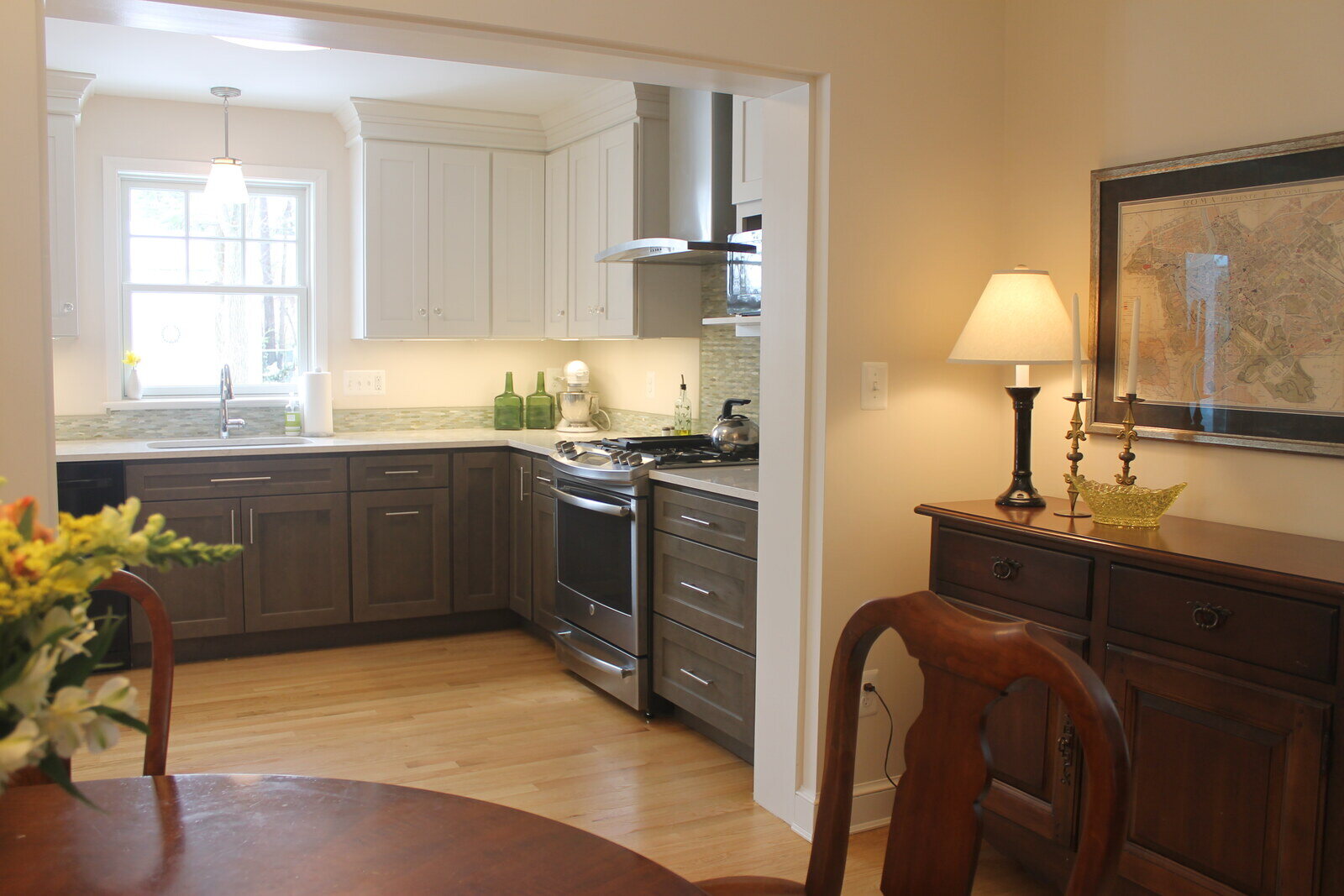 Compact and bright bathroom remodel featuring wood cabinetry and marble countertops by Villa Builders in Annapolis, MD