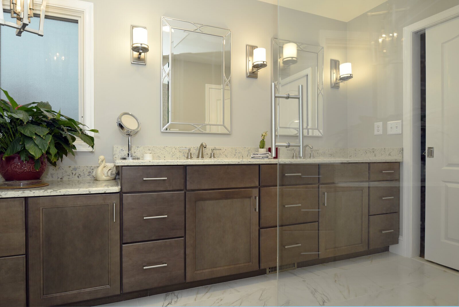 Contemporary bathroom with custom vanities and dual mirrors in a remodeled home by Villa Builders in Annapolis, MD