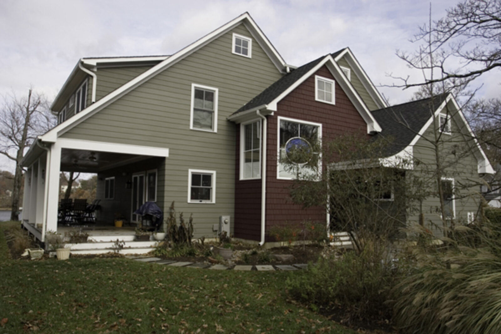 Craftsman-style home with green and burgundy siding, remodeled by Villa Builders in Annapolis, MD