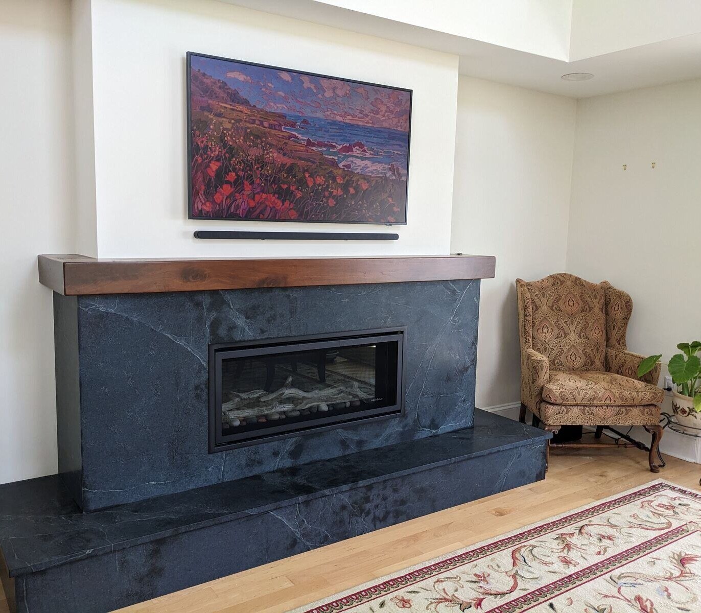 Modern living space featuring a sleek black fireplace and vibrant wall art, designed by Villa Builders in Annapolis, MD