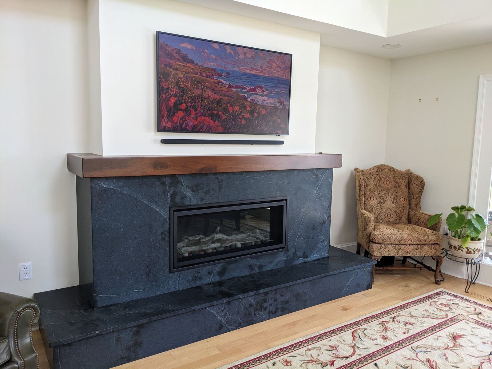 Modern living space featuring a sleek black fireplace and vibrant wall art, designed by Villa Builders in Annapolis, MD