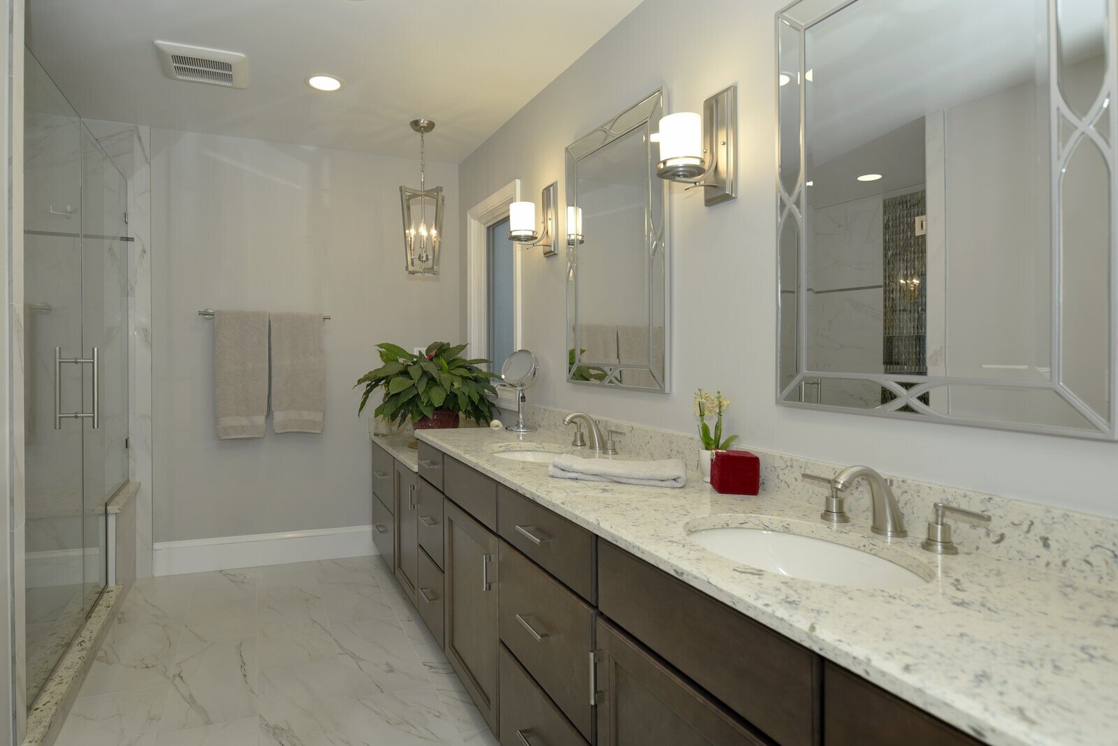 Stylish bathroom with a walk-in shower and modern finishes in a remodeled Annapolis home by Villa Builders