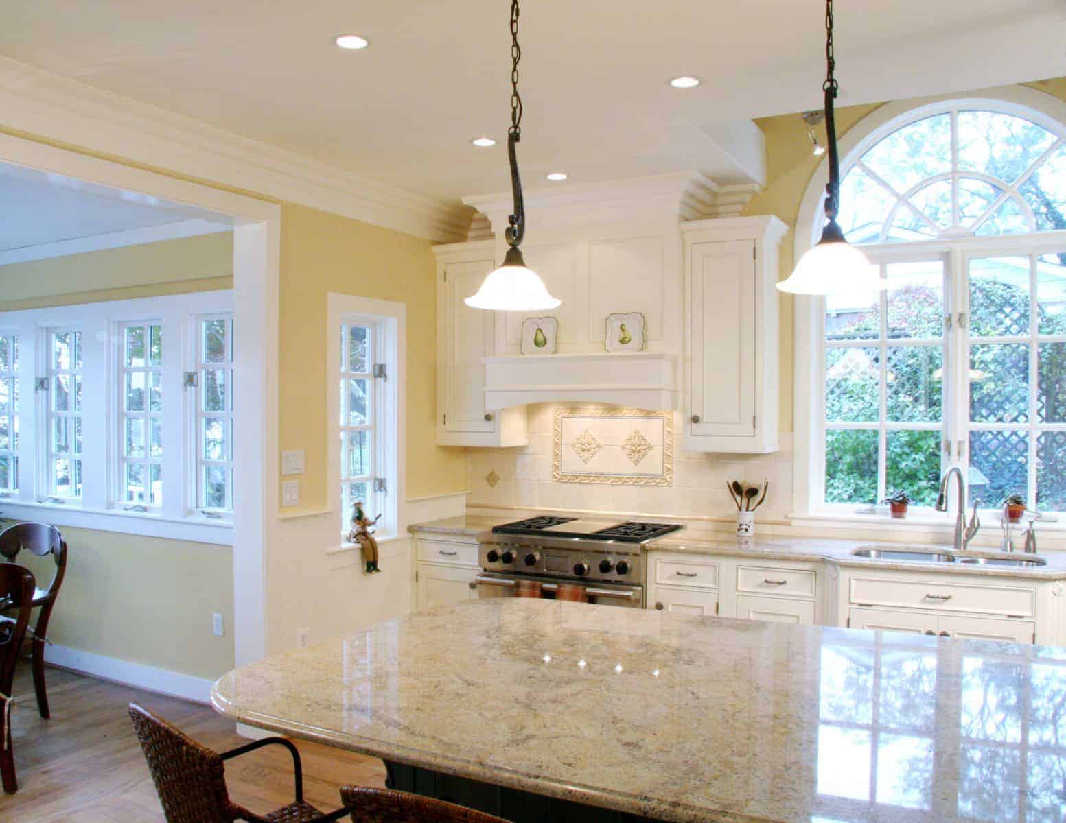 Bright and spacious remodeled kitchen with white cabinets and a large central island by Villa Builders in Annapolis, Maryland