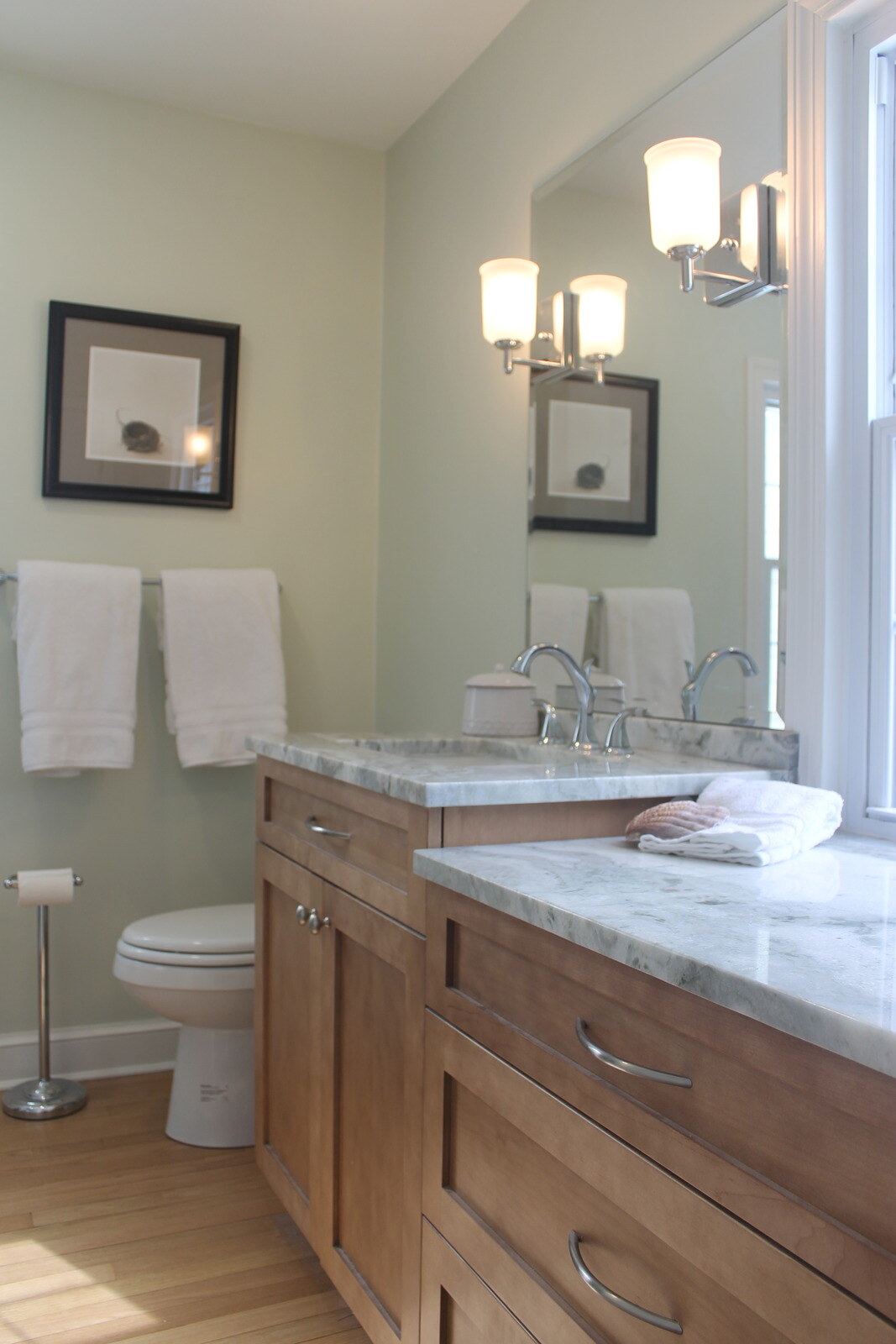 Bathroom remodel featuring warm wooden cabinetry and a bright, airy design, completed by Villa Builders in Annapolis, MD