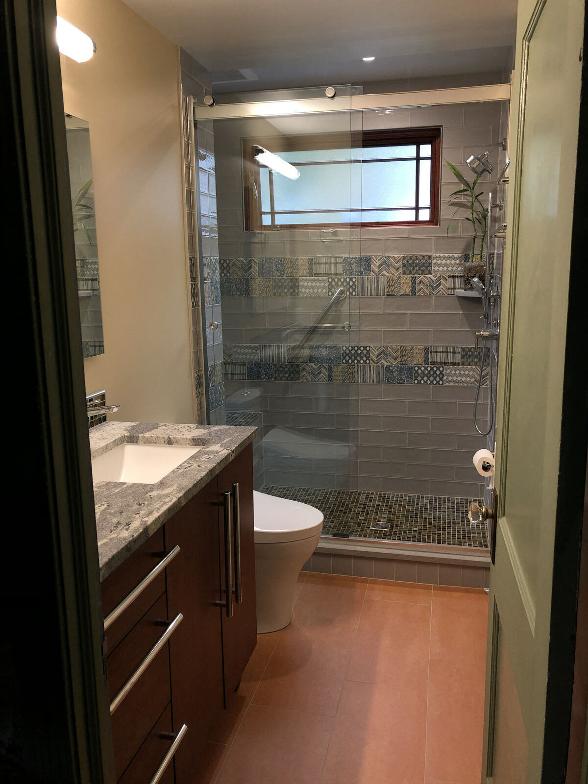 Modern bathroom renovation with a custom tile shower and natural lighting by Villa Builders in Annapolis, MD